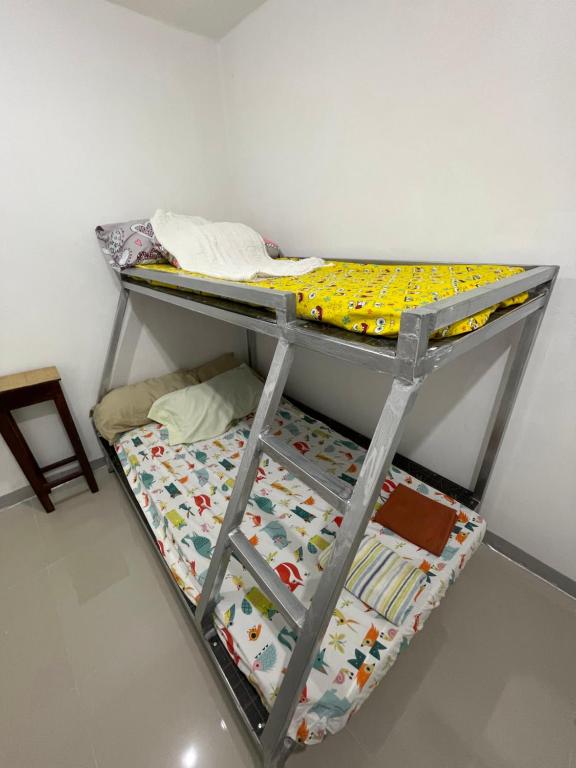 a metal bunk bed in a room with a mattress at Kwarto-2-Go in Pontud