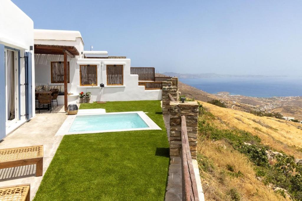 a villa with a swimming pool and a view of the ocean at Felicia Exclusive Villa - Private Pool in Arnados