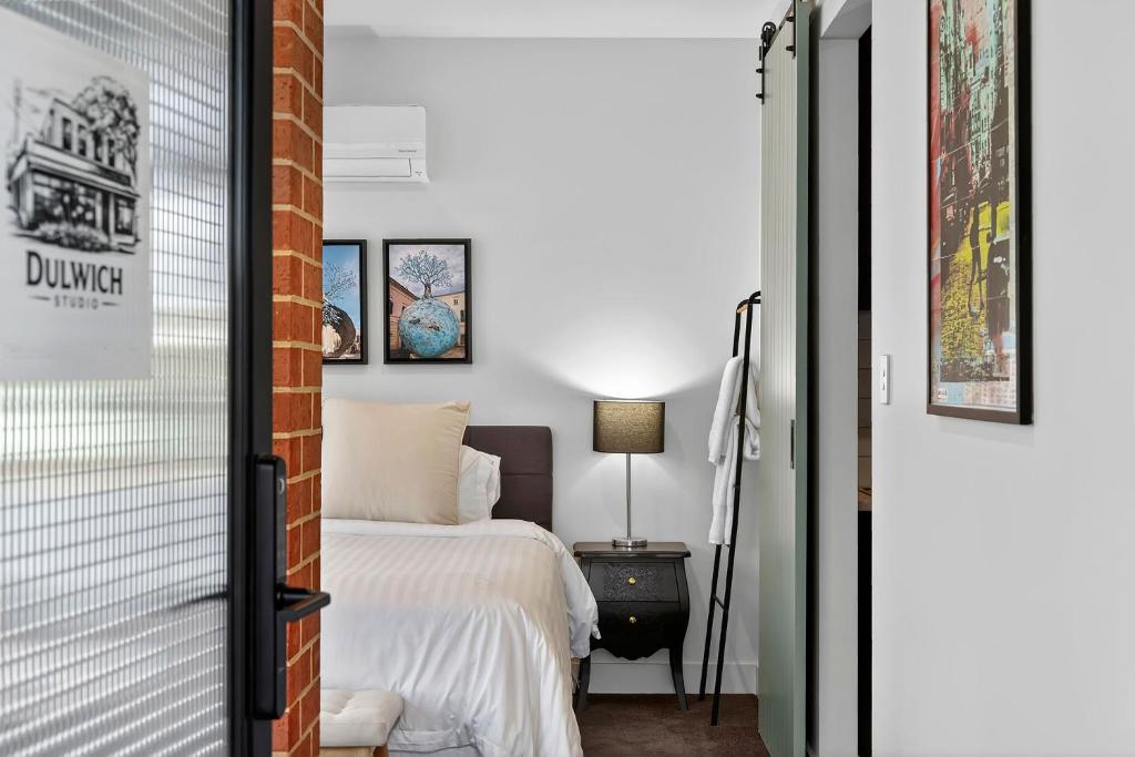 a guest bedroom with a bed and a door leading to a bedroom at Dulwich Studio in Rose Park