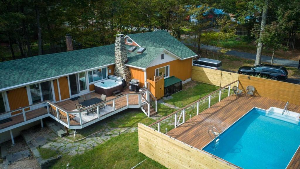 an aerial view of a house with a swimming pool at Dip and Dink Catskills Poolside Oasis in White Lake