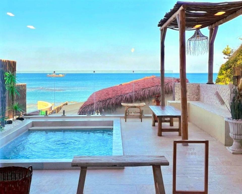 a swimming pool with a view of the beach at Ulsan Guyu Stay in Ulsan