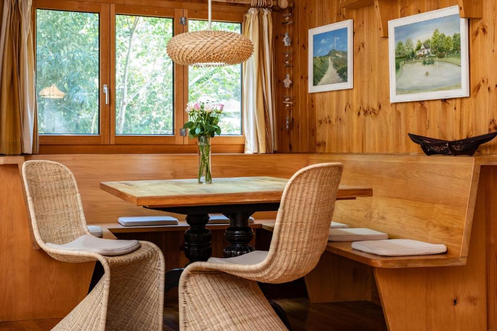 a dining room with a wooden table and chairs at The Deck in Elizabeth Beach