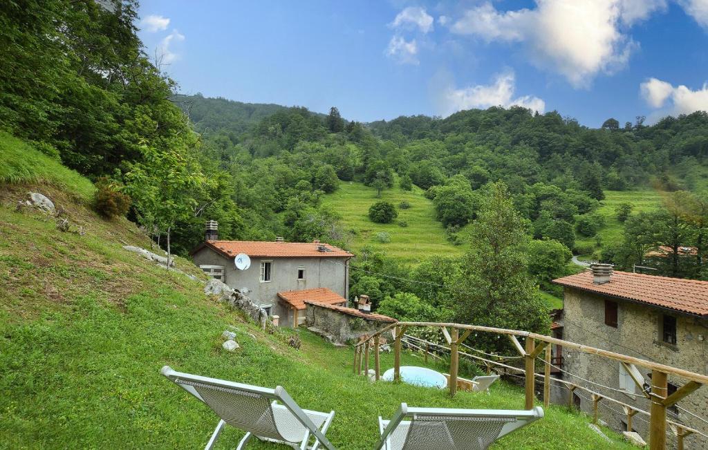 a couple of chairs sitting on top of a hill at Casa Sant'anna in Stazzema