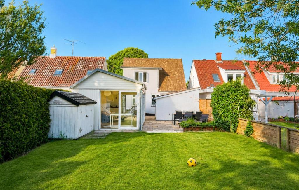 a house with a yard with a soccer ball on the grass at 3 Bedroom Gorgeous Home In Faaborg in Faaborg