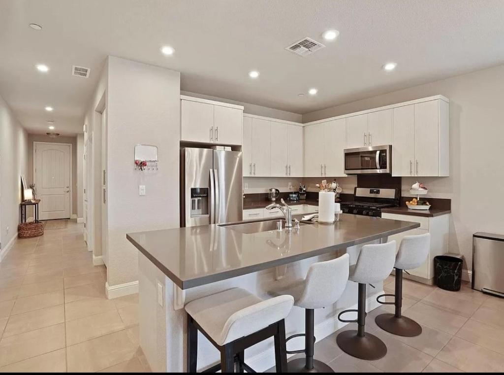 a kitchen with a large island with white cabinets at Vip Class One Real Comfort 3 Bedrooms in Lodi