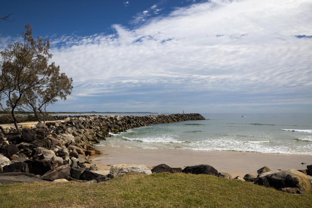 a large group of rocks on the beach at Reflections Evans Head - Holiday Park in Evans Head