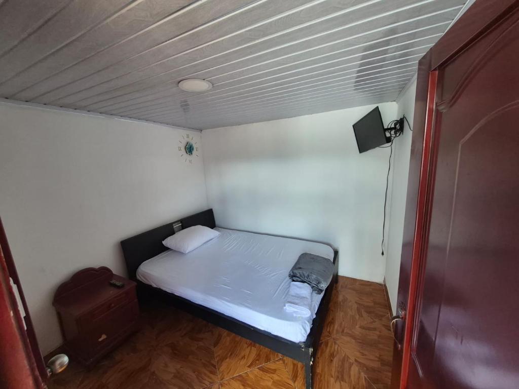 a small room with a small bed in it at Hotel Típico Delphos in Filadelfia