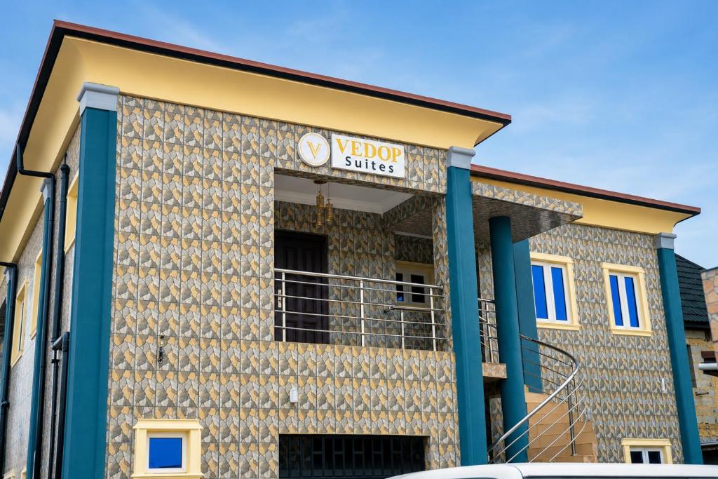 a building with a sign on the side of it at Executive Private Bed and Bath in Otta