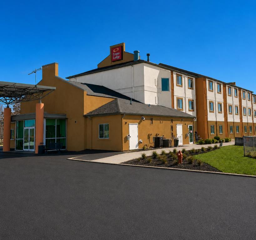a large building with a red sign on top of it at Econo Lodge Menomonie in Menomonie