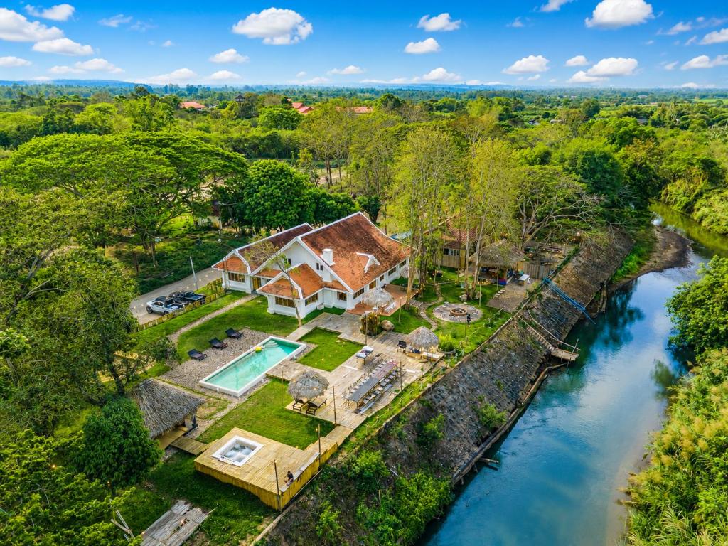 an aerial view of a house next to a river at Ping Dara Pool Villa Party in Ban San Pa Sak