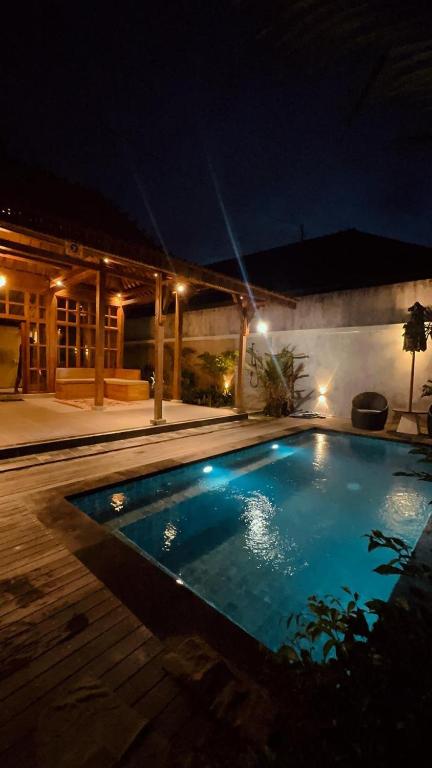 a swimming pool in a yard at night at Nara Housee' in Darmasaba