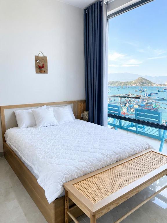 a bedroom with a bed with a view of the ocean at Đầm Nại Hotel in Ninh Hải