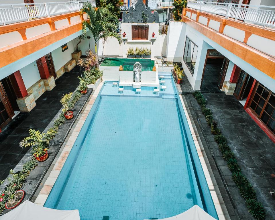 an overhead view of a swimming pool in a building at Natasya Kuta Beach Hotel in Kuta