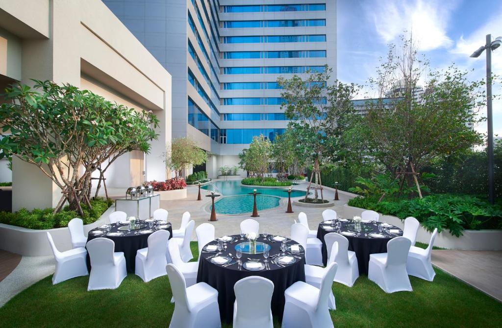 A landscaped courtyard pool set up for a formal outdoor event.