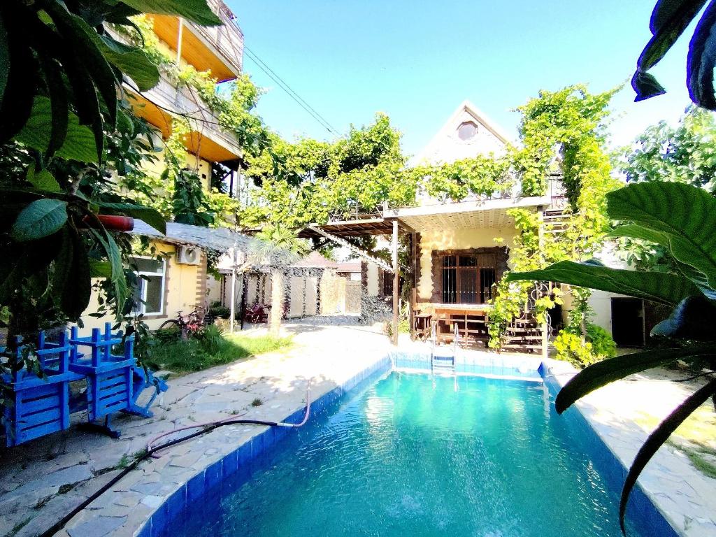 a swimming pool in front of a house at Baku "ISR" Guest House in Sǝnqǝçal Stansiyası