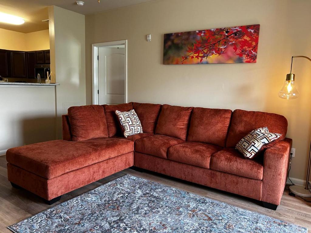a brown leather couch in a living room at Regatta Getaway in Fayetteville