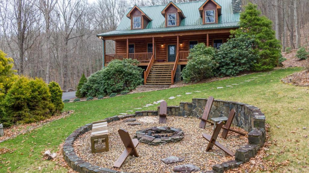 a log cabin with a fire pit in front of it at The Forge in Lansing