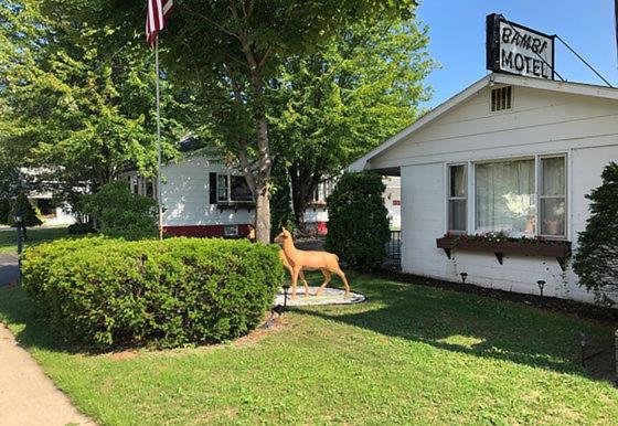 a statue of a horse in front of a house at Bambi Motel in East Tawas