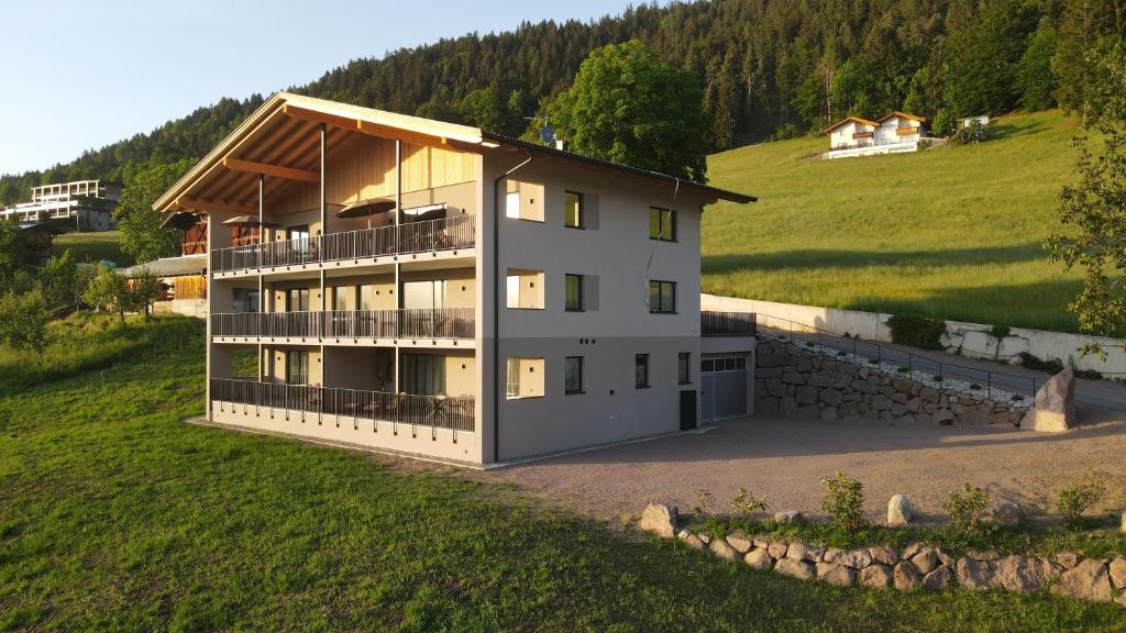 an aerial view of a house on a hill at Hinterrainer Nature Apartments- New in Avelengo