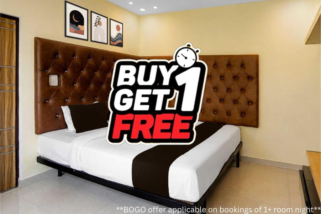 a bed with a buy get free sign on it at Super Hotel O Kashi Ghat Varanasi Formerly Ganga Valley in Rāmnagar