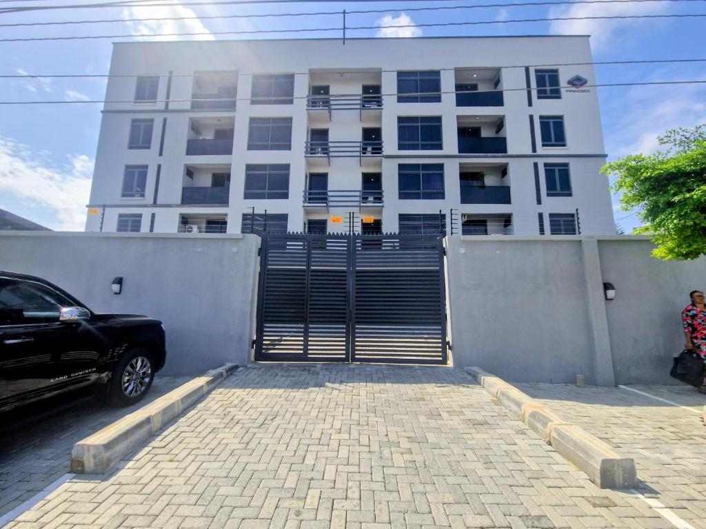 a building with a staircase in front of a parking lot at Habitat Service Apartment in Ilado