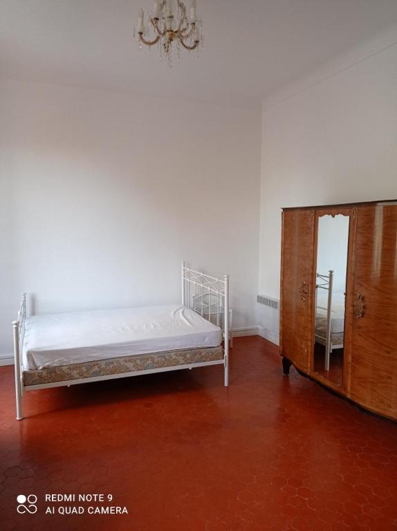a bedroom with a white bed and a dresser at GautierNice in Nice