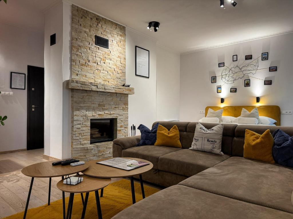 a living room with a couch and a fireplace at L69 Apartments - Angel's Apartment in Banská Bystrica
