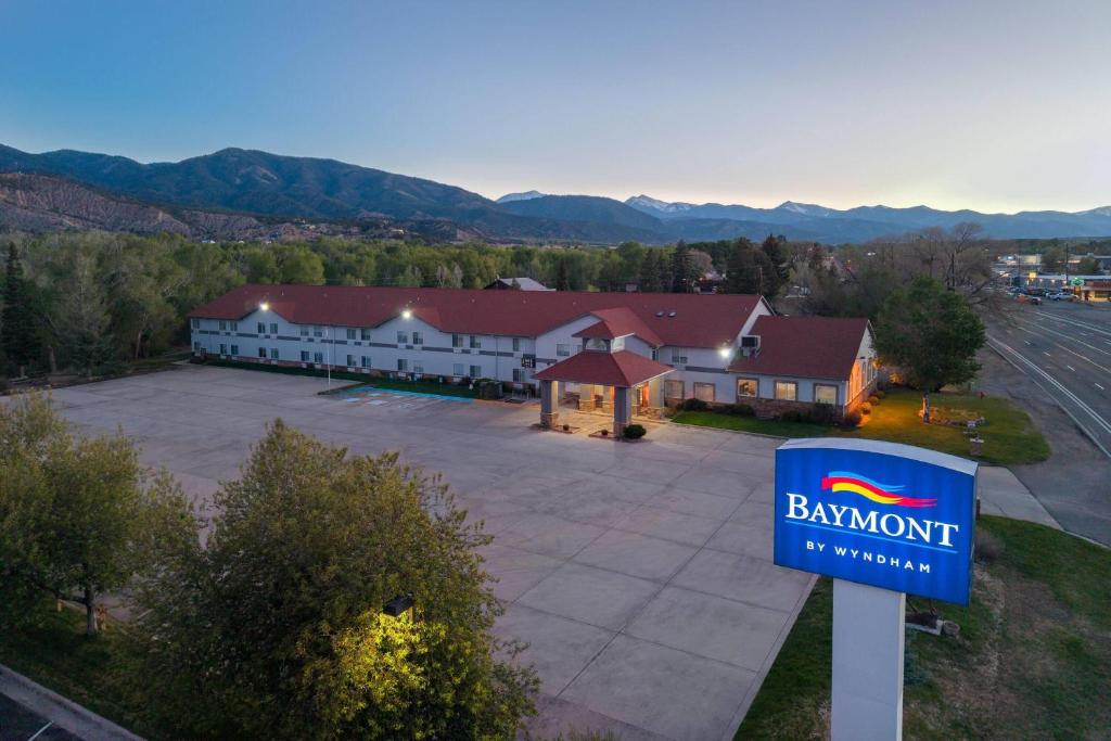 a sign in front of a building with a parking lot at Baymont by Wyndham Salida in Salida