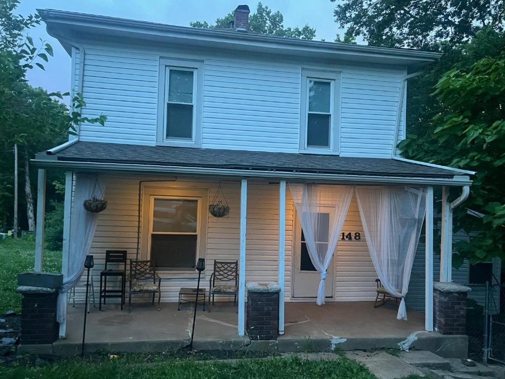 a house with chairs on a patio in front of it at Tranquil Retreat-Off the Beaten Path in Independence