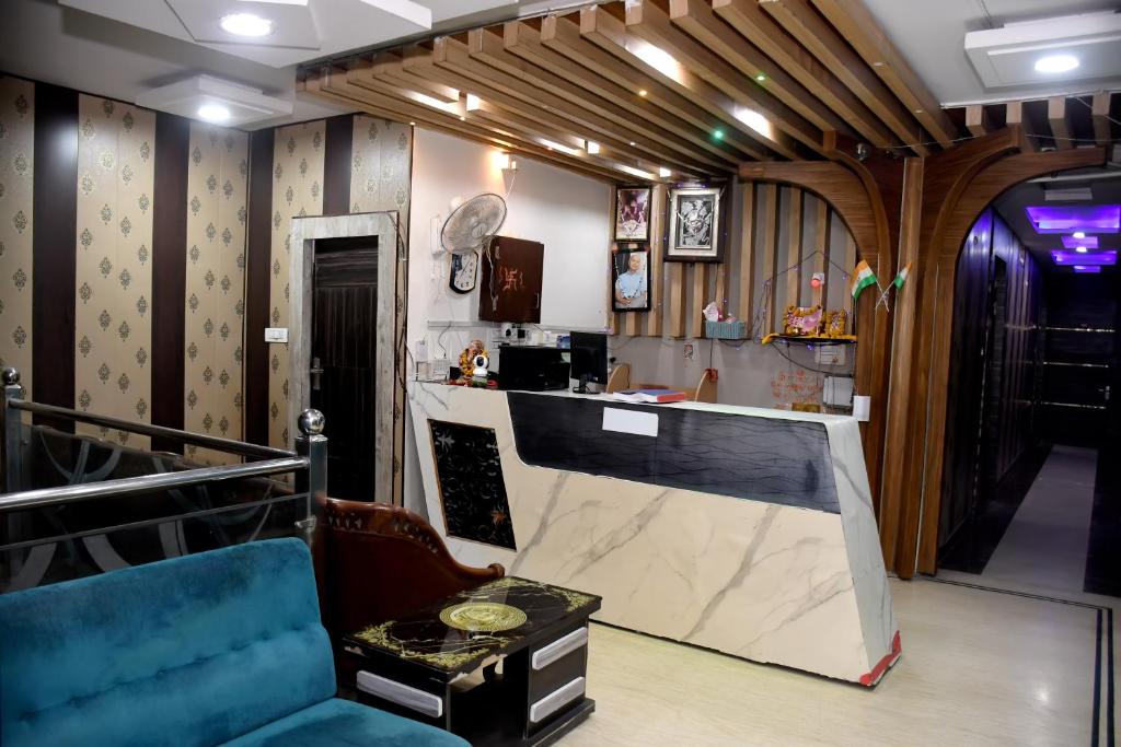 a bar in a room with a blue chair and a counter at Hotel J P Residency in Datia
