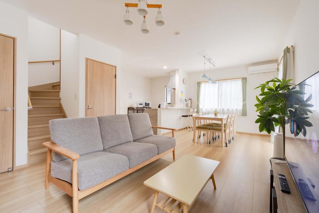 a living room with a couch and a table at Fujiyama Stay102 in Fujinomiya