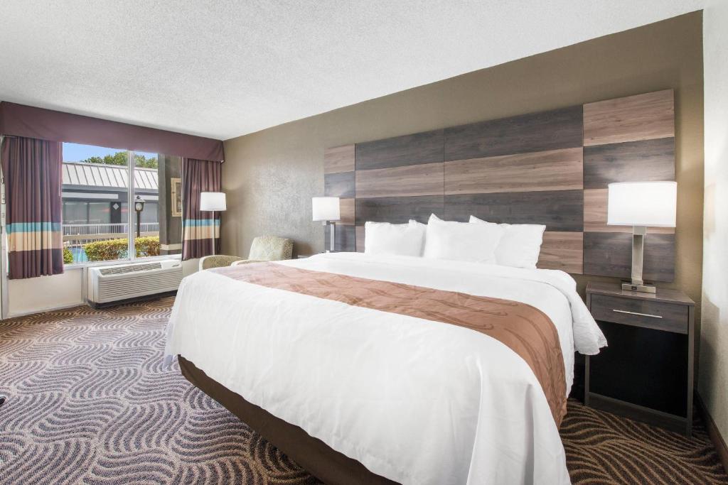 a hotel room with a large bed and a window at Quality Inn Concord Kannapolis in Concord