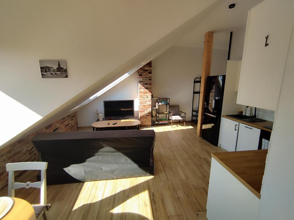 a living room with a staircase in a house at Apartament Karmelicka in Wadowice