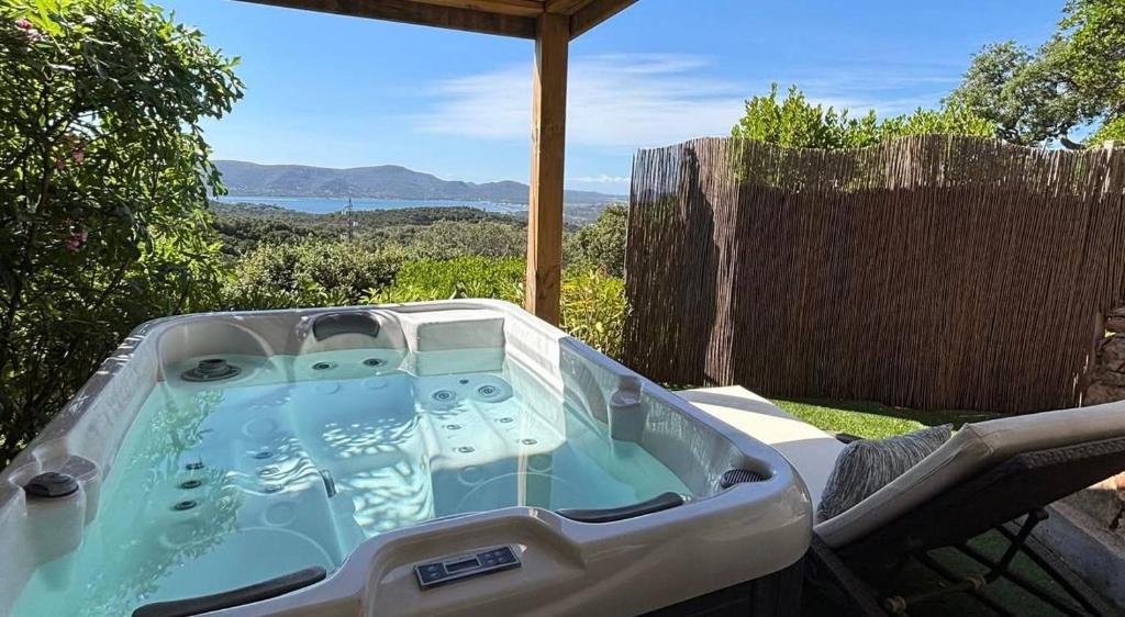 a bath tub sitting on top of a patio at La Lézardière - Suites de Prestige & Spas Privatifs in Porto-Vecchio