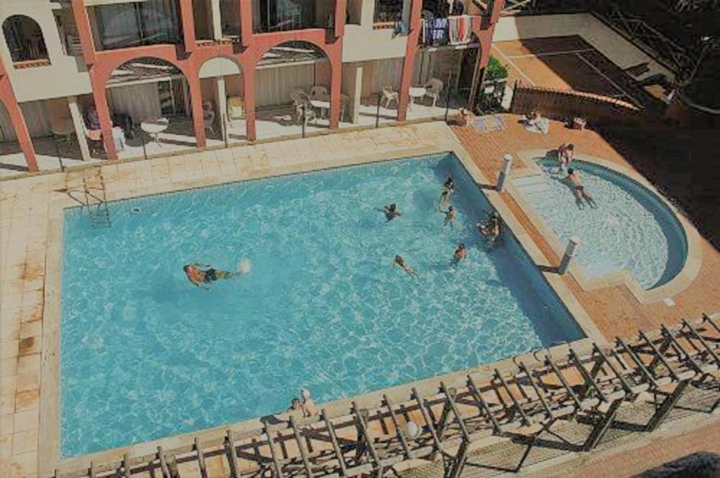 a group of people swimming in a swimming pool at Hotel Alhambra in Cap d&#39;Agde
