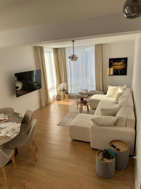 a living room with a couch and a table at Paradise Relax Apartament in Zalău