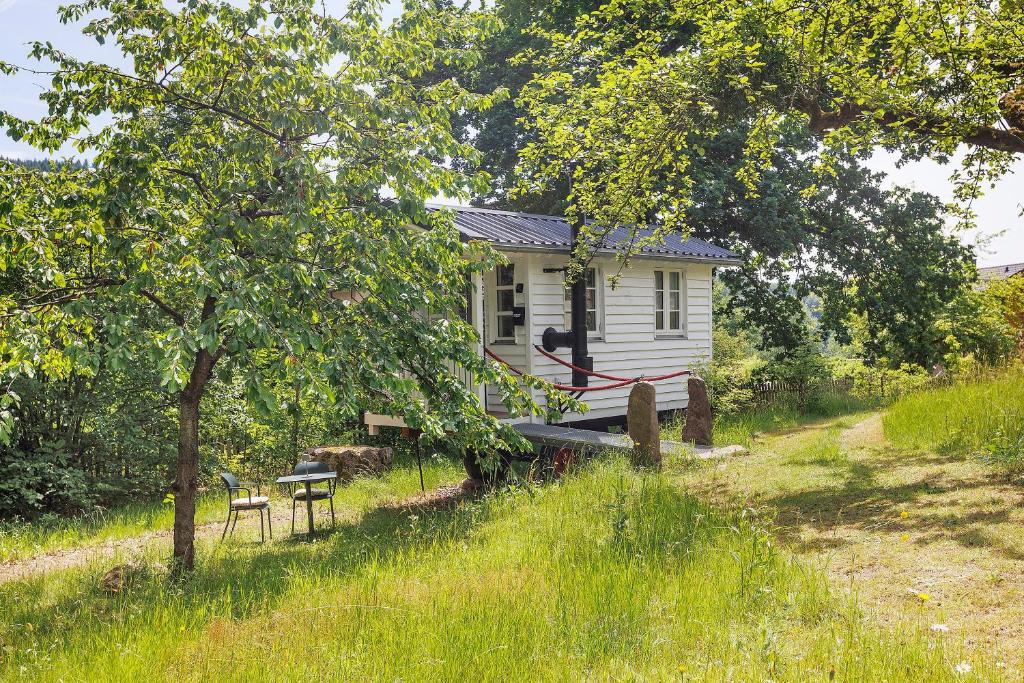 a small white house in the middle of a field at Waldwagen Altes Forstamt Sinntal in Sinntal