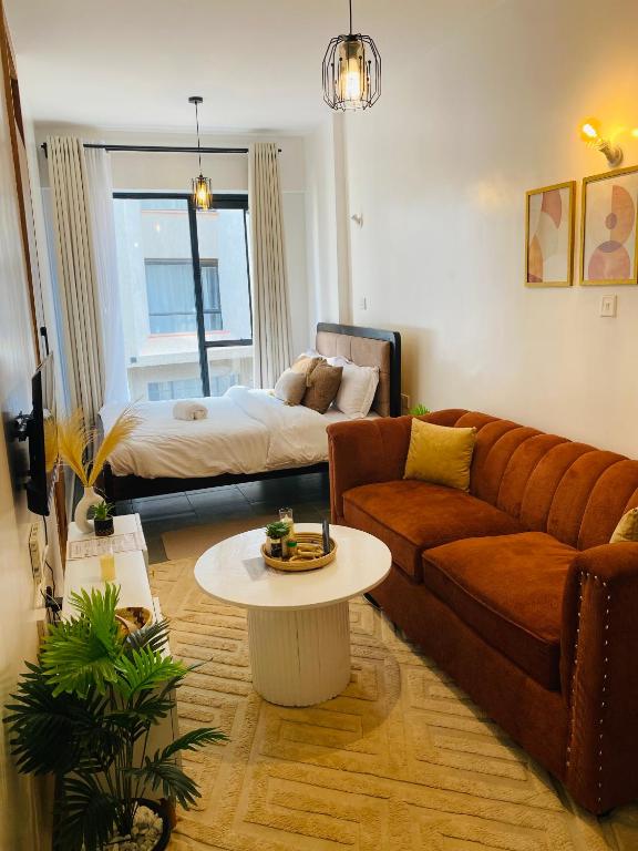a living room with a couch and a table at Nomads nest suites in Kiambu