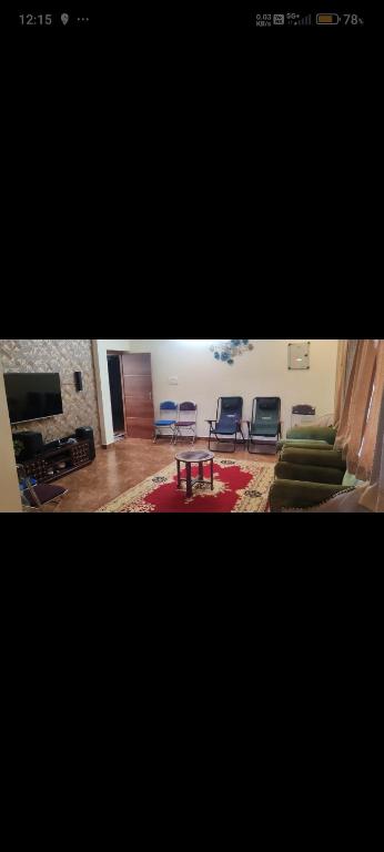 a living room with a couch and chairs and a table at VVR villa in Tirupporūr