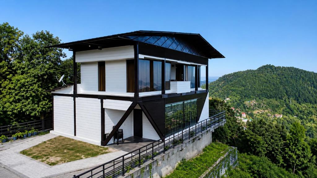 a house with a black roof on top of a building at Sky Villa Ramgarh Mukteshwar in Mukteshwar