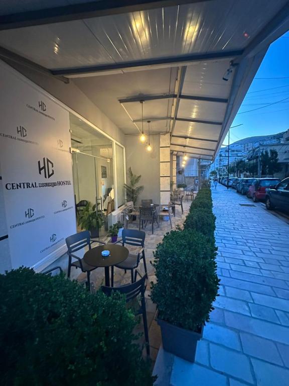 a patio with chairs and tables on a building at Central Boutique Hostel in Sarandë