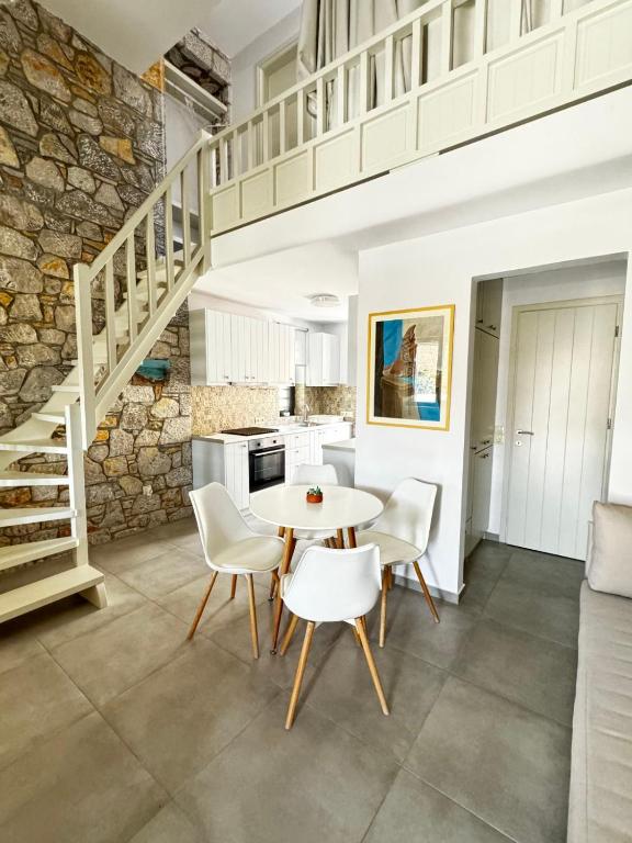 a kitchen and dining room with a table and chairs at Casa Petra Astypalea in Astypalaia