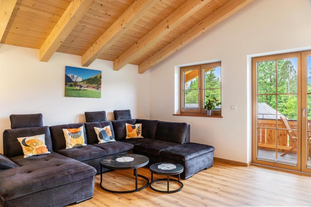 a living room with a couch and tables at Haus Stoabock in Wallgau
