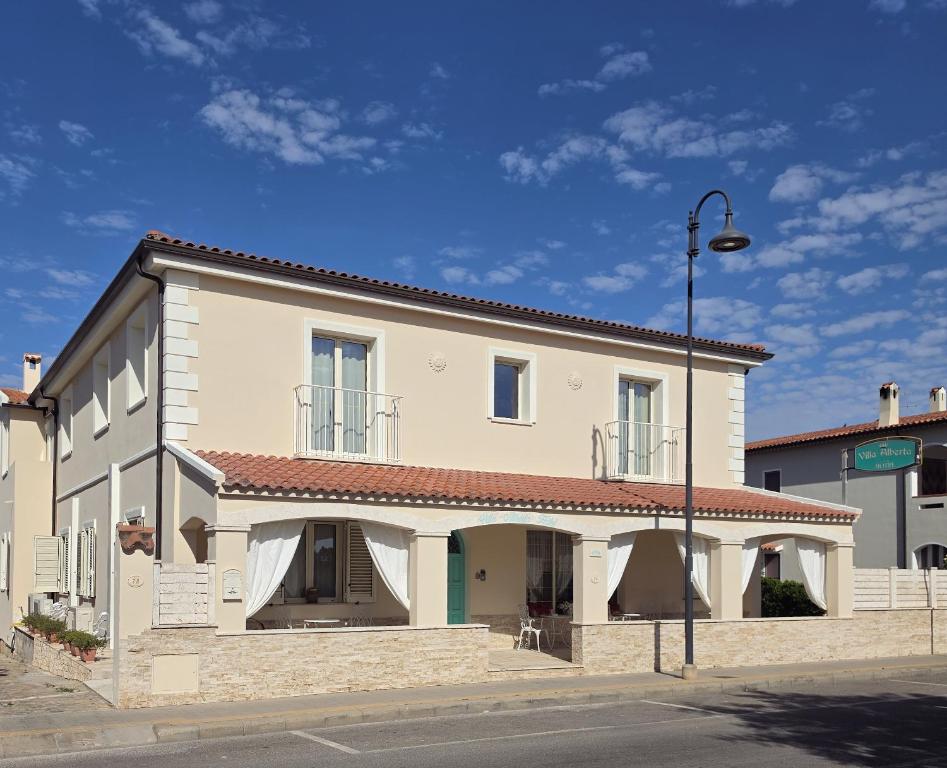 a large white building on the side of a street at Villa Alberta Hotel in Pula