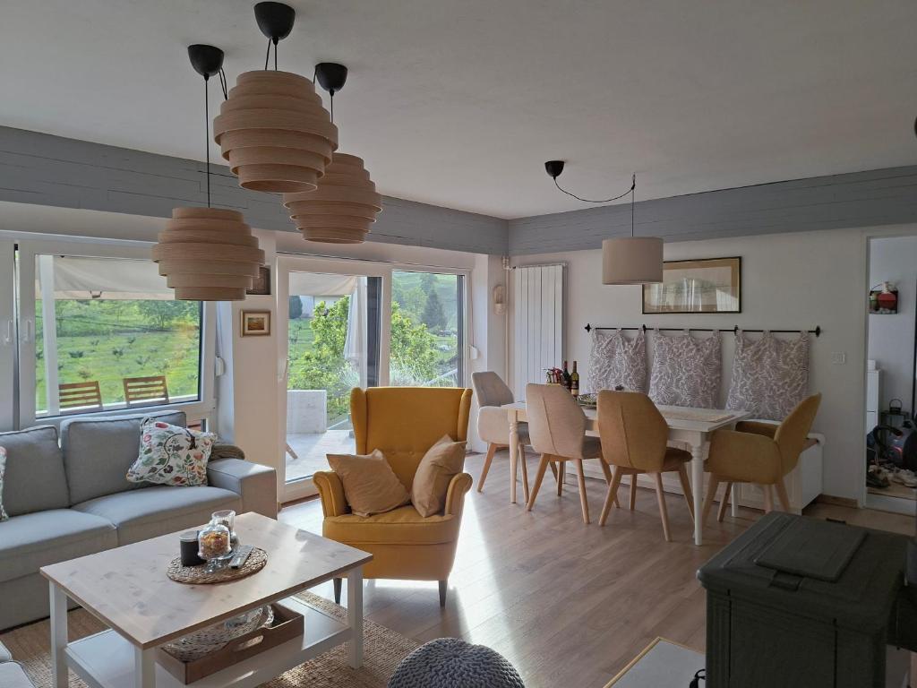 a living room with a couch and a table at Villa Arboreta in Tuhelj