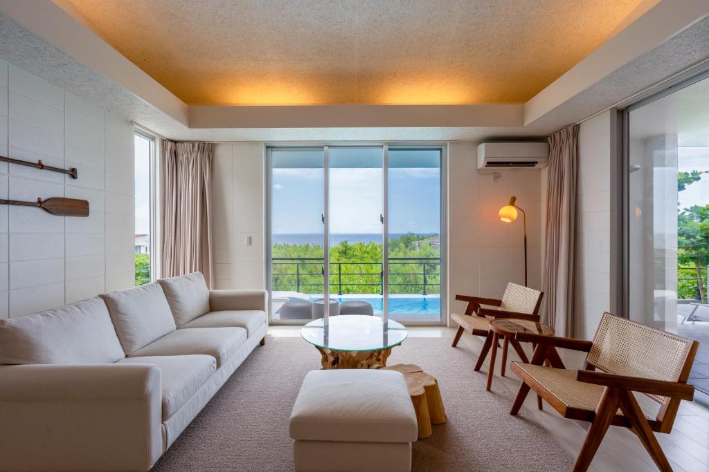 a living room with a couch and a table at COCO VILLLA 沖縄今帰仁-Okinawa nakijin in Nakijin