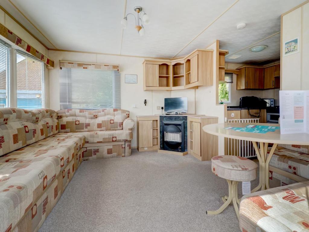 a room with boxes and a table and chairs at Sunshine & Smiles in South Hayling