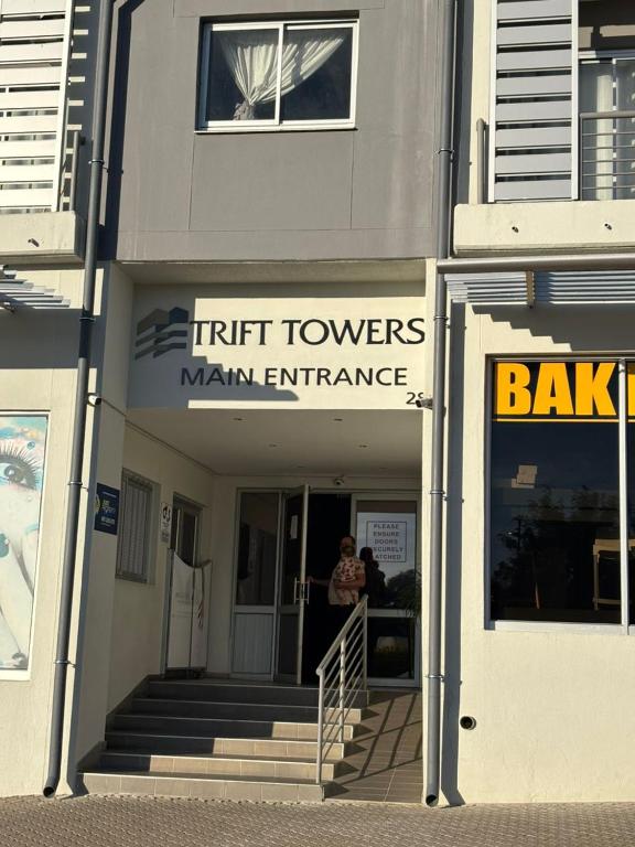 a man standing in the doorway of a building at M&M Nest in Windhoek