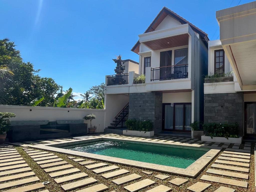 a house with a swimming pool in front of it at Mimpi Ayung Villas by AGATA in Bringkit