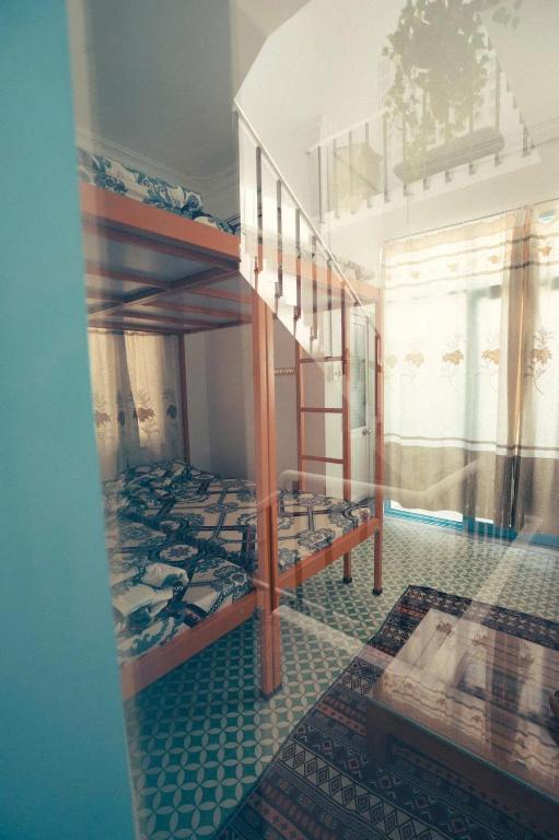 a room with two bunk beds and a staircase at OHA Homestay in Quy Nhon